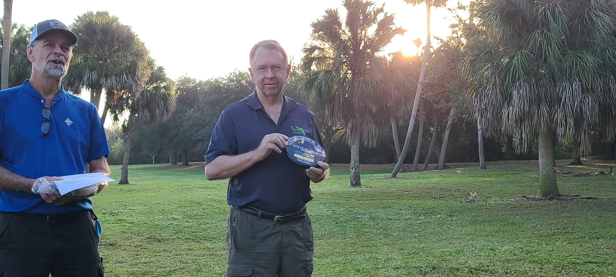 Steve Slasor holding his named Florida Hall commemorative award during the induction presentation